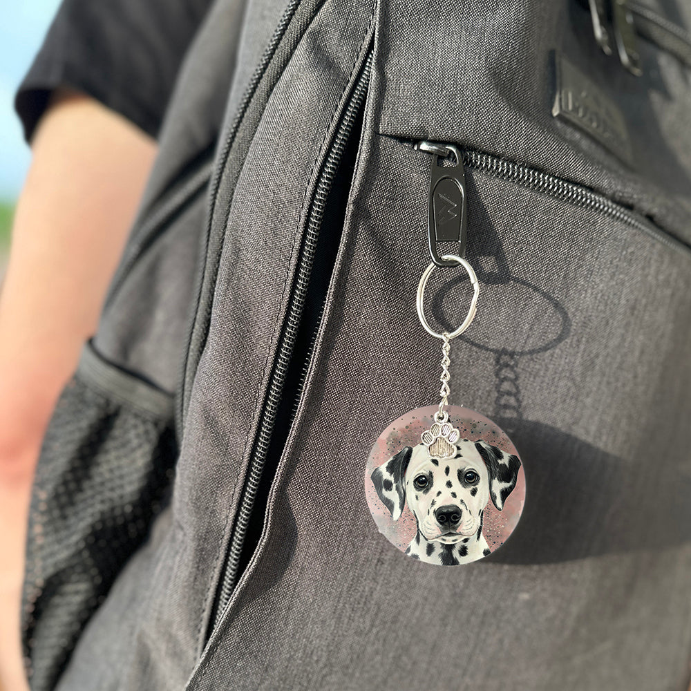 Keychain with a dog's face attached to a gray bag
