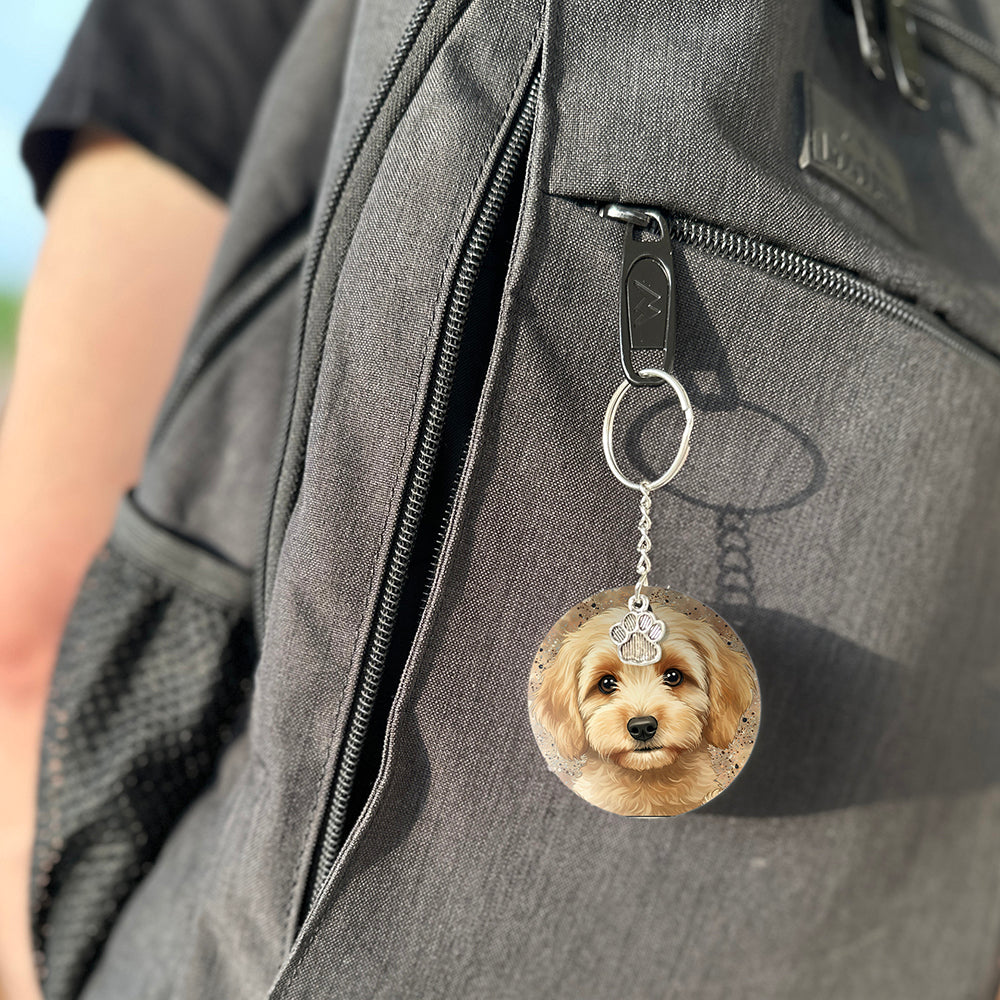 Keychain with a dog's face attached to a gray bag