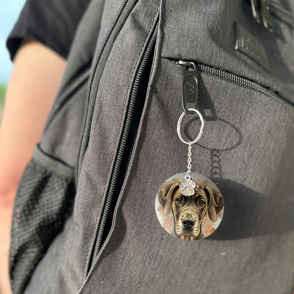 Keychain with a dog's face attached to a gray bag