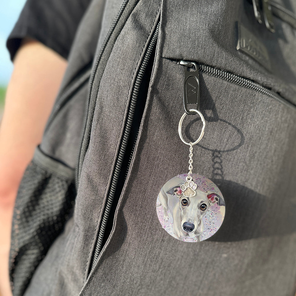 Keychain with a dog's face attached to a gray bag