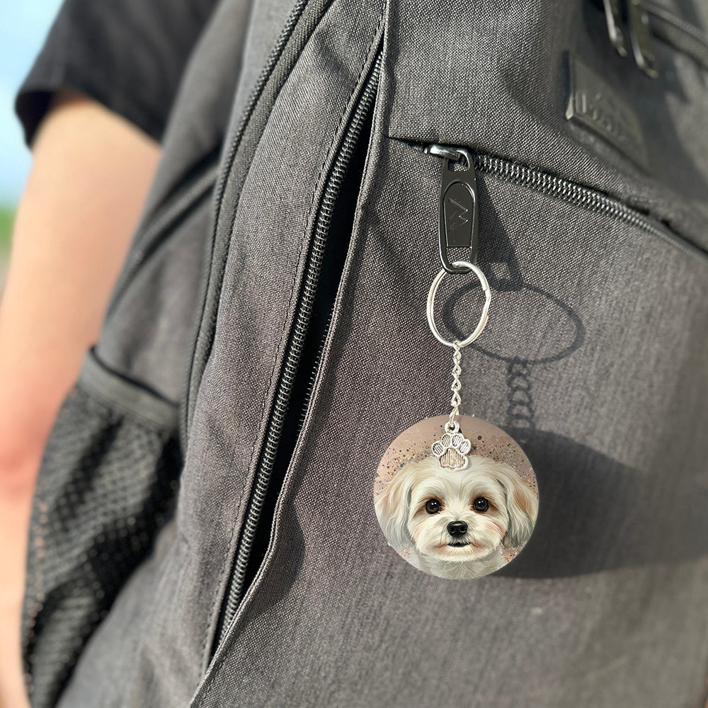 Keychain with a dog's face attached to a gray bag