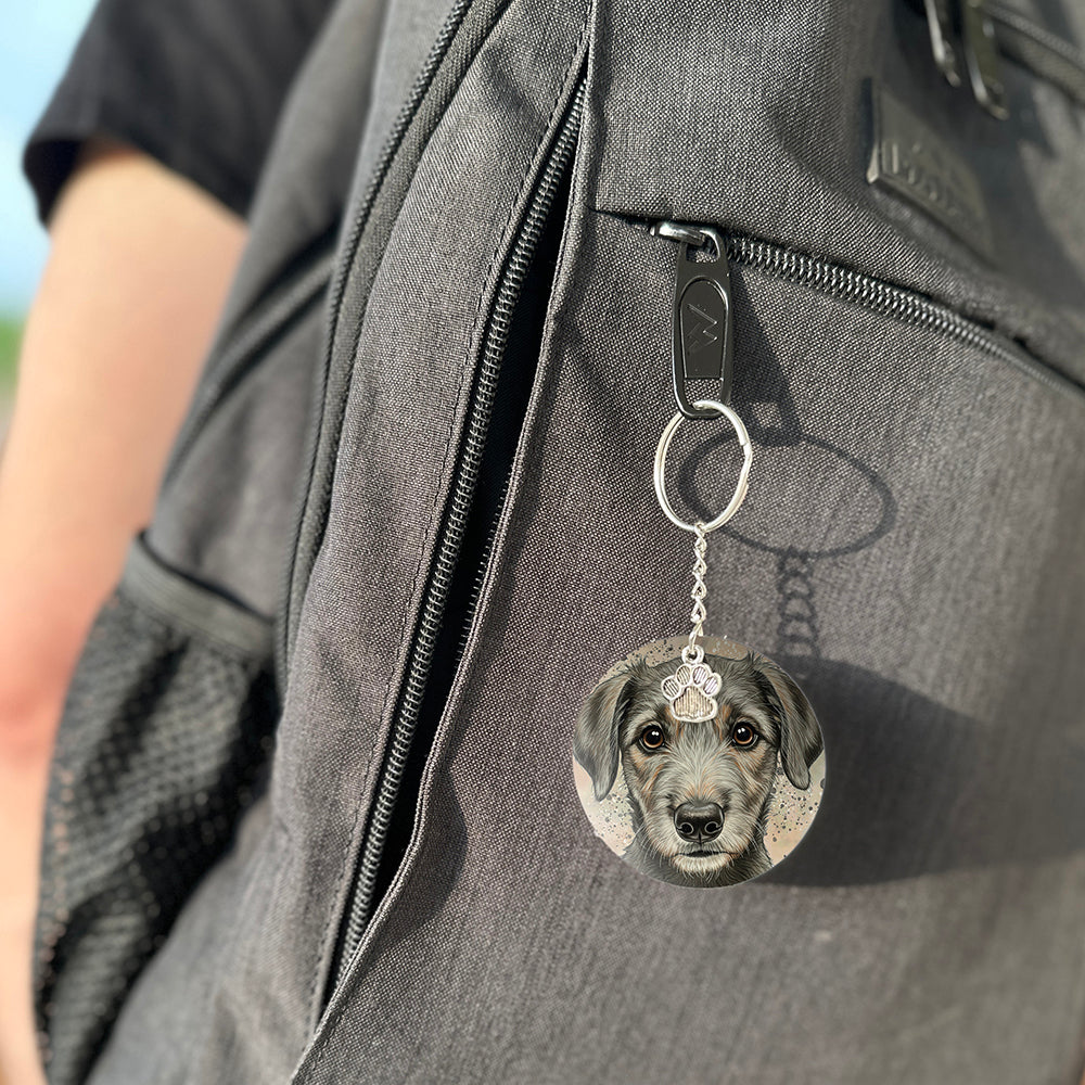 Keychain with a dog's face attached to a gray bag