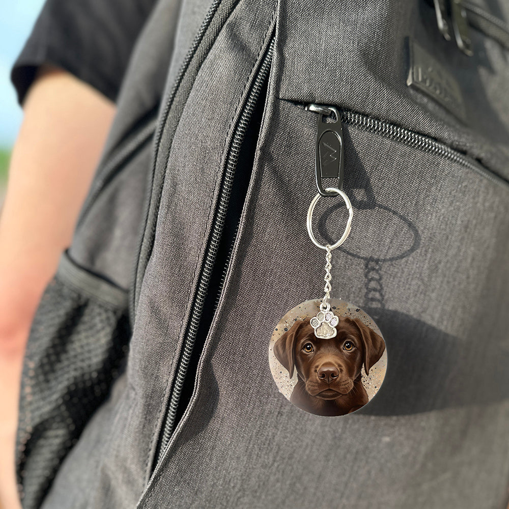 Keychain with a dog's face attached to a gray bag
