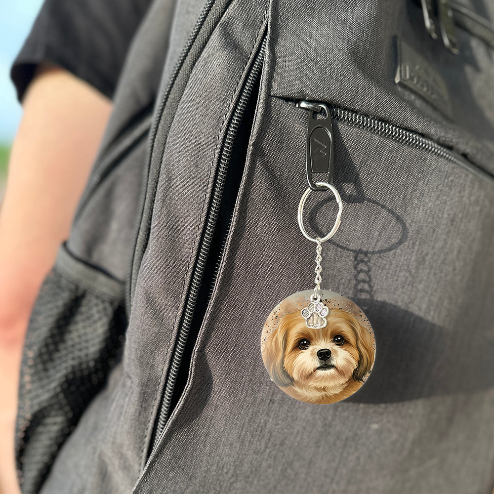 Keychain with a dog's face attached to a gray bag