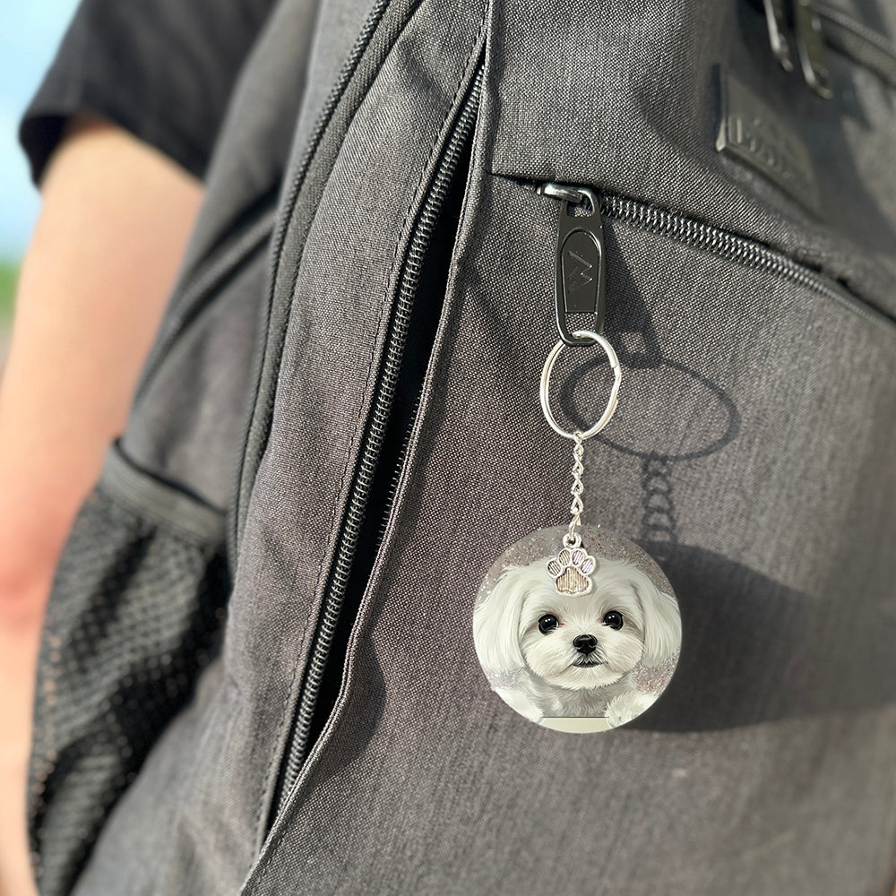 Keychain with a dog's face attached to a gray bag