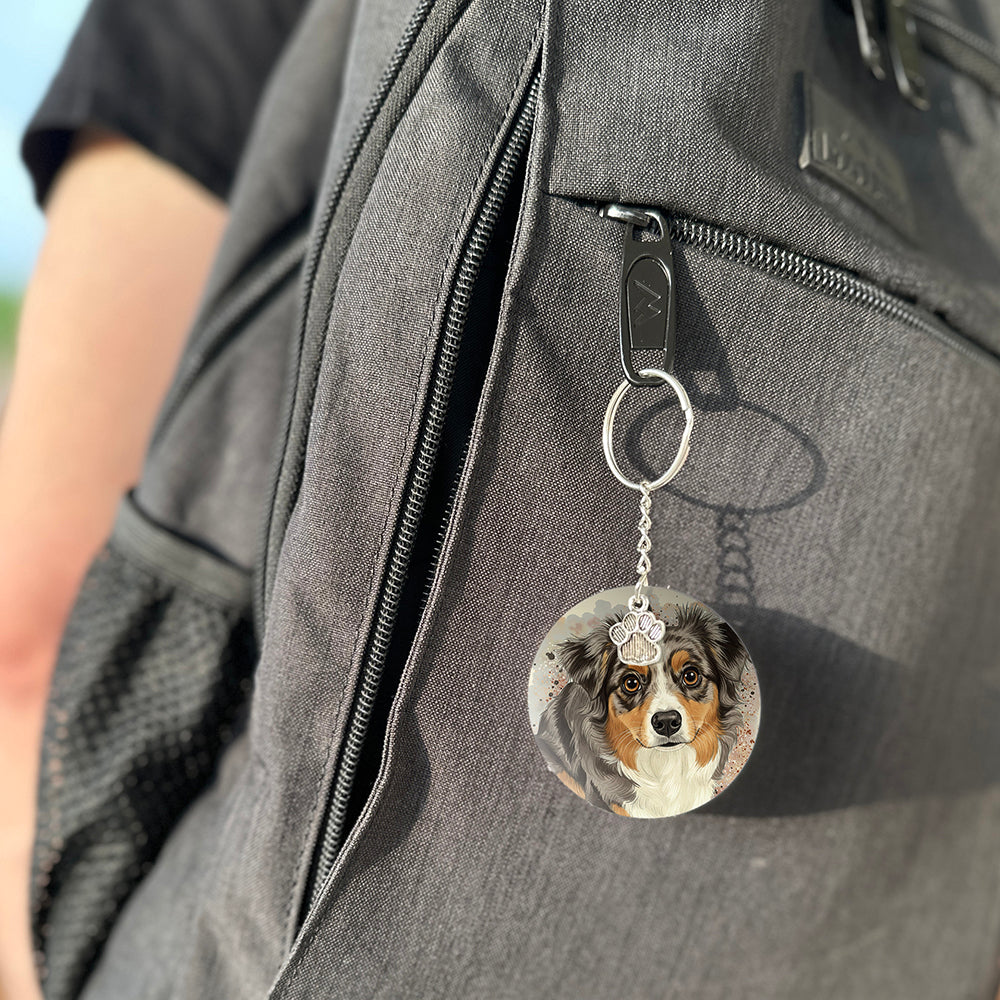 Keychain with a dog's face attached to a gray bag