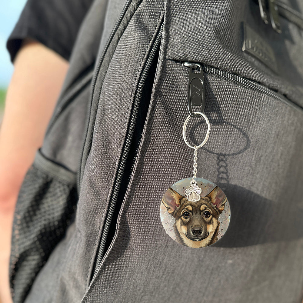 Keychain with a dog's face attached to a gray bag