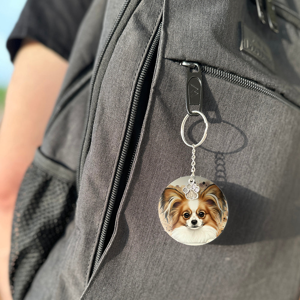 Keychain with a dog's face attached to a gray bag