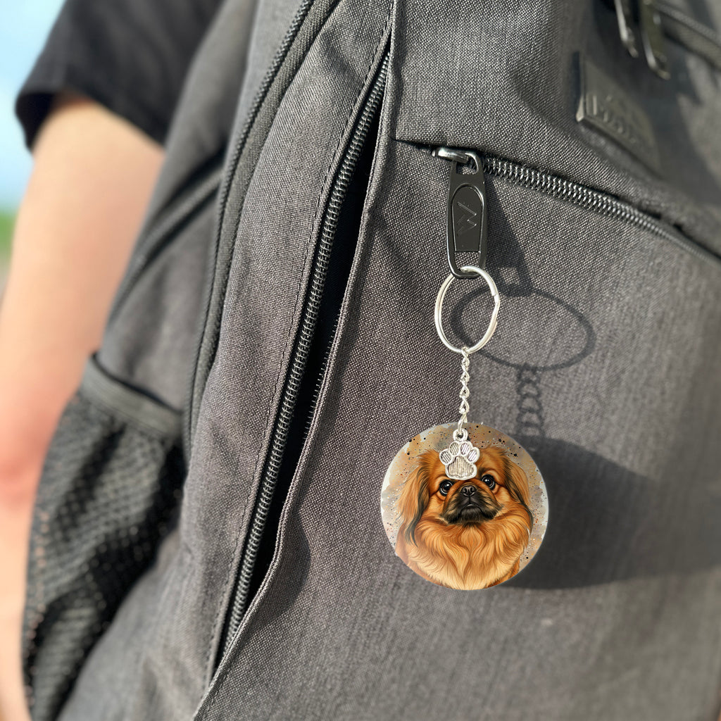 Keychain with a dog's face attached to a gray bag