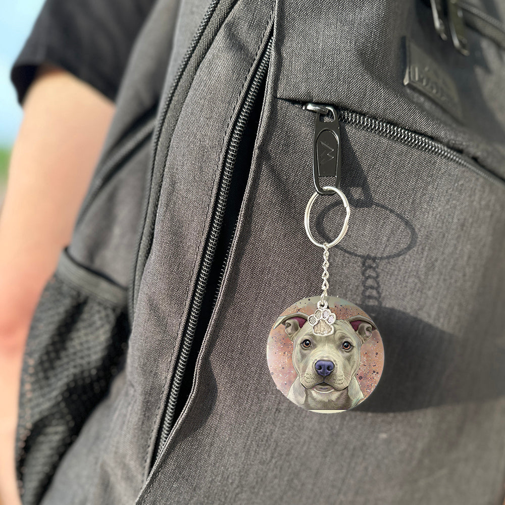 Keychain with a dog's face attached to a gray bag