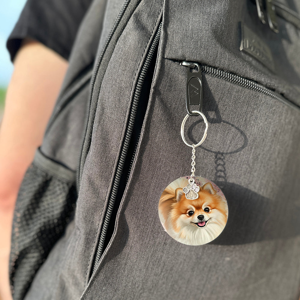 Keychain with a dog's face attached to a gray bag