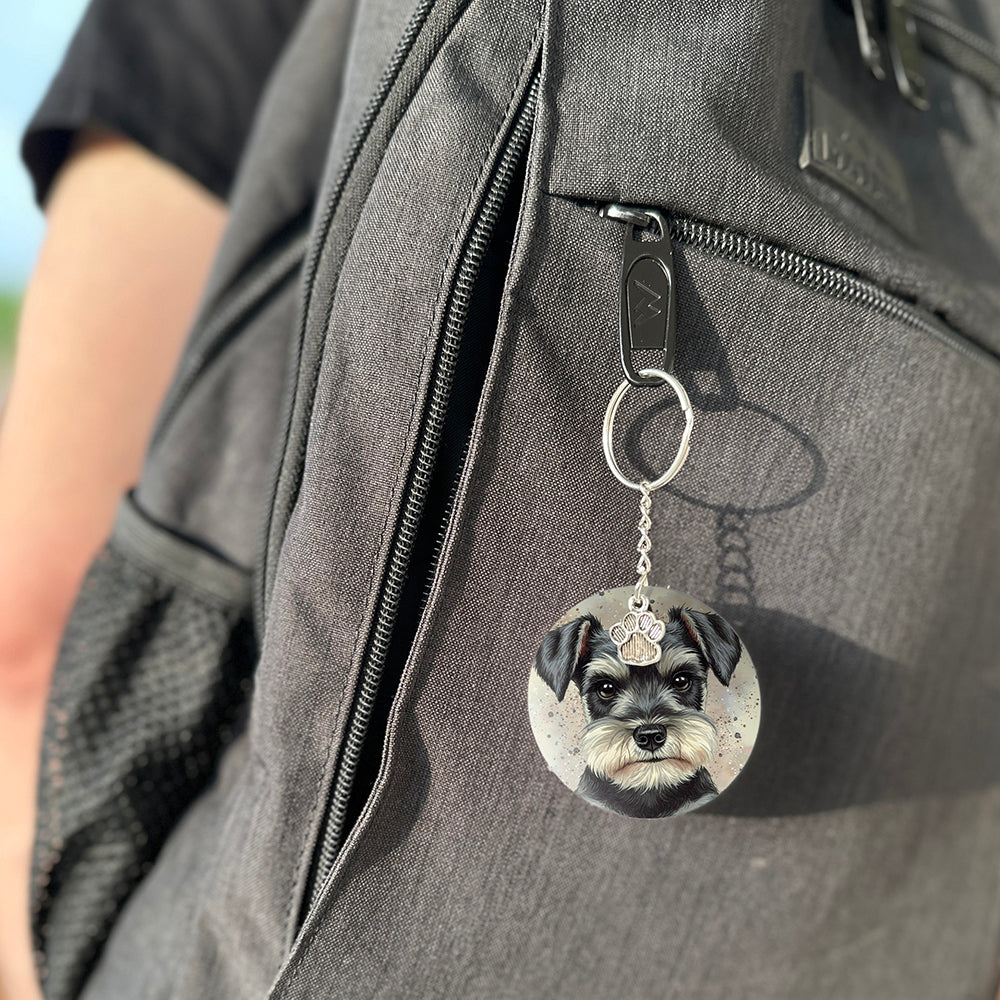Keychain with a dog's face attached to a gray bag
